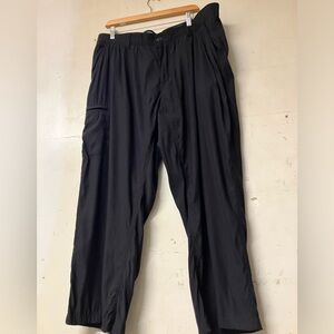 Black outdoor/casual pants with zippered pockets.